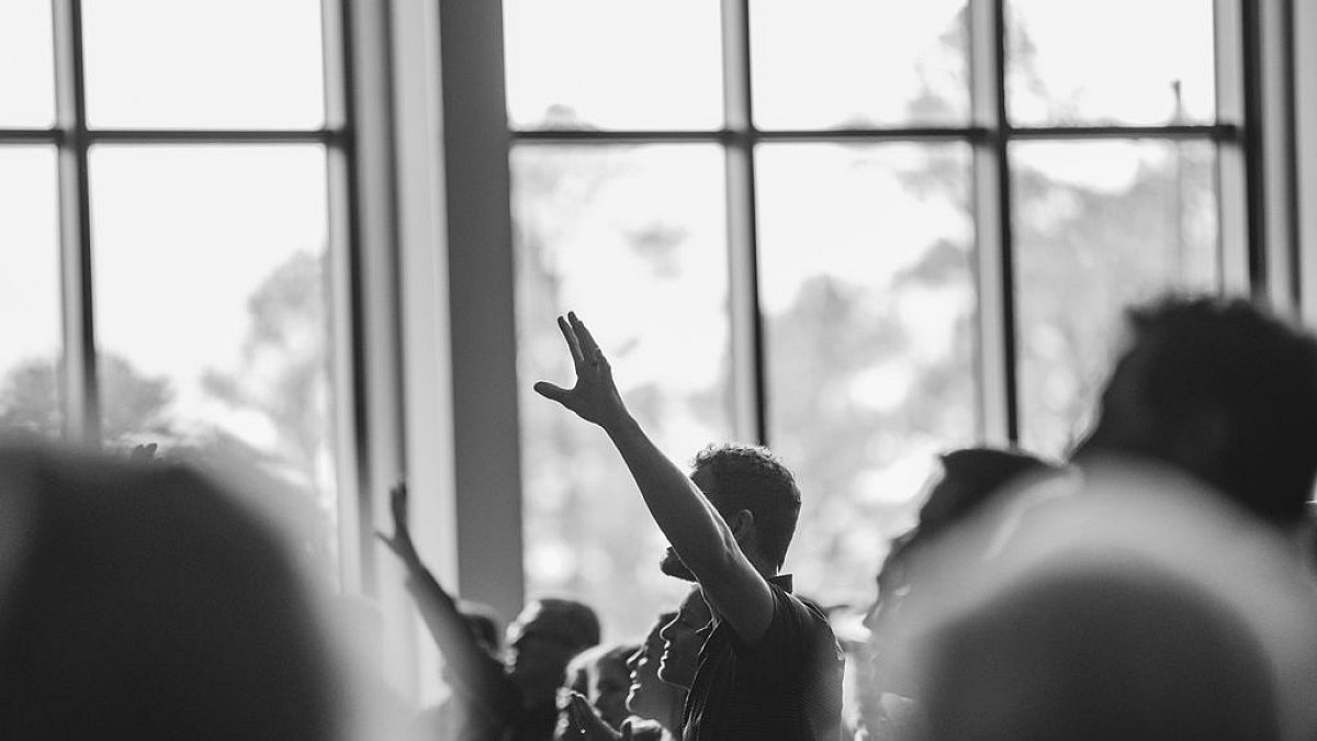 Hero Image Hand Raised in Worship