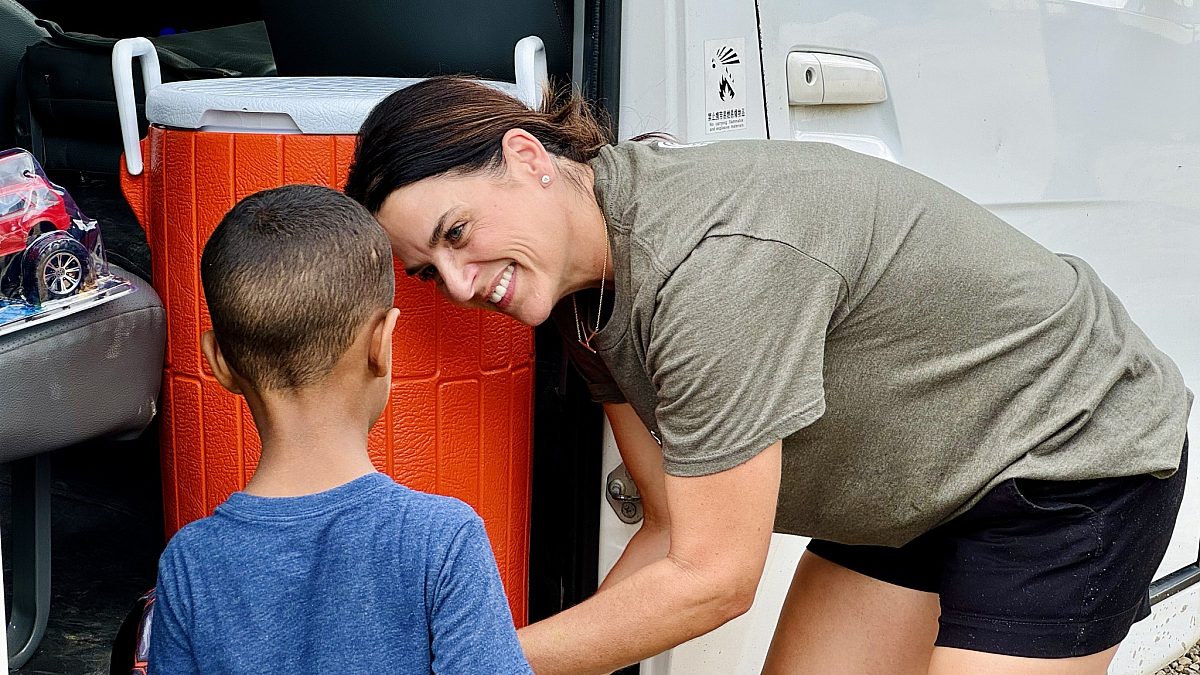 Mission Trip Woman Serving Child