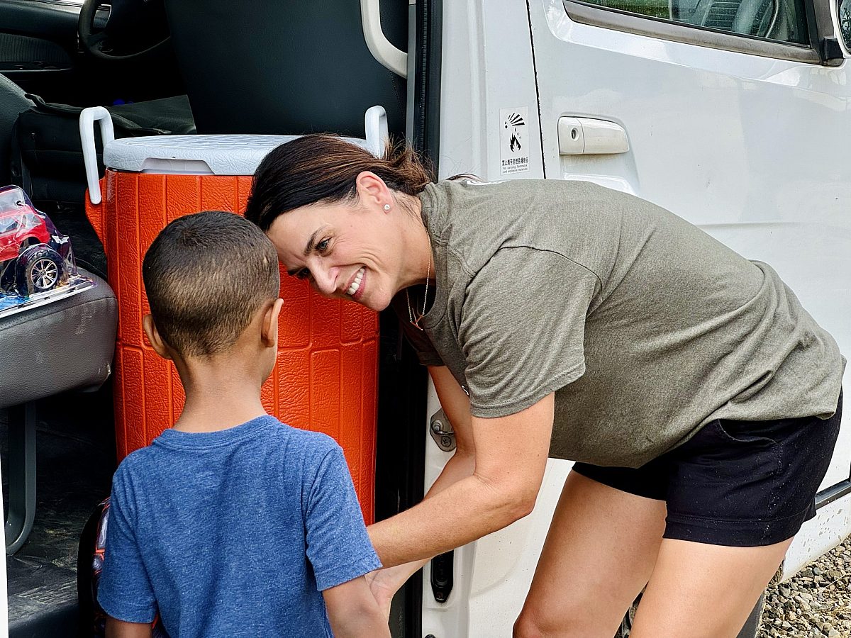 Mission Trip Woman Serving Child